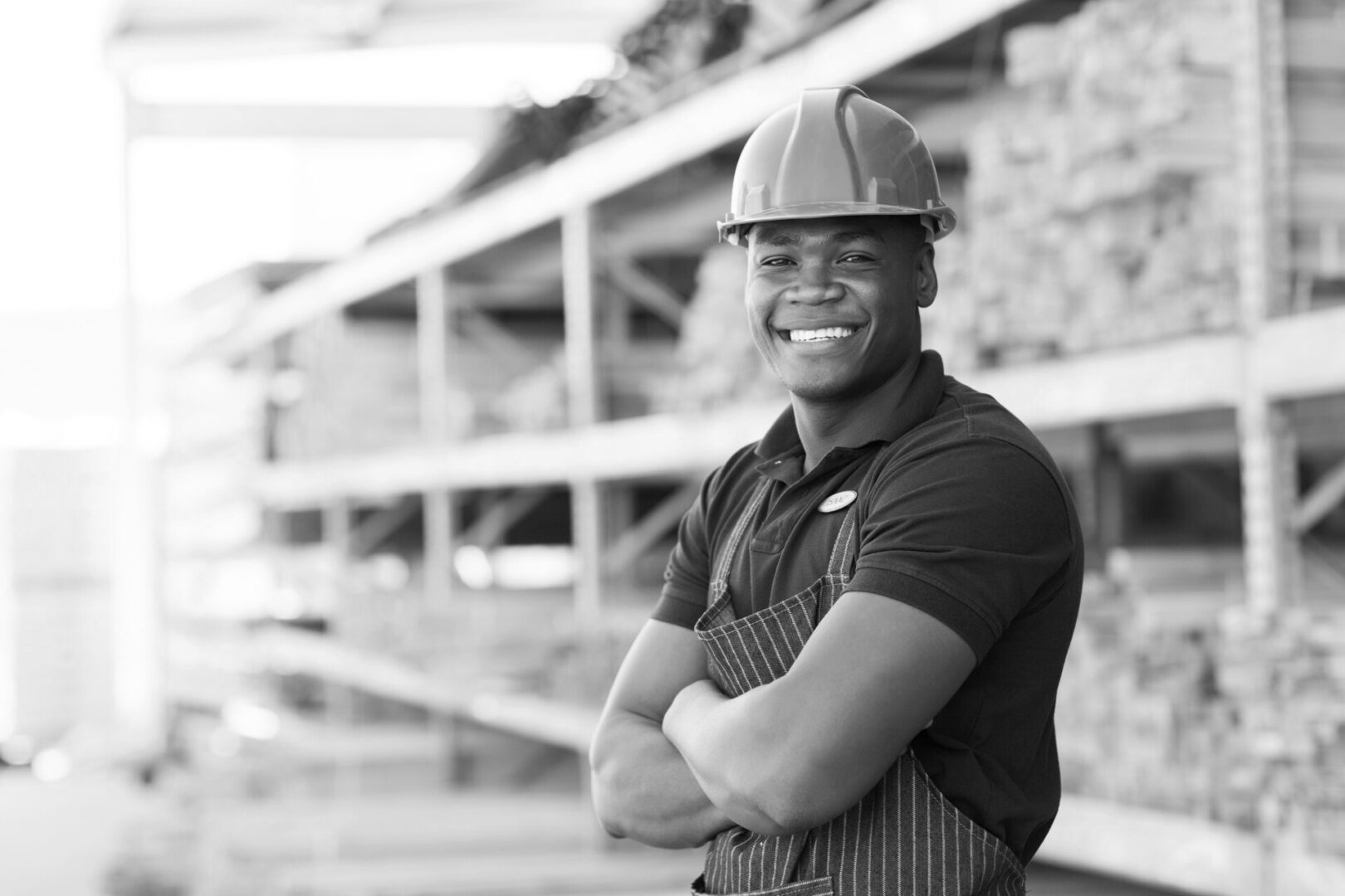 happy african industrial worker standing at building material warehouse