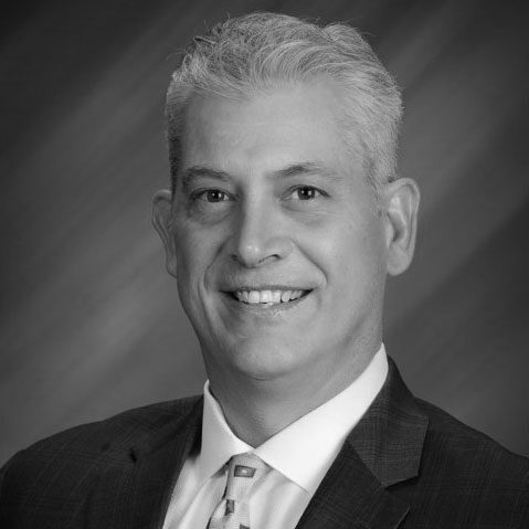 A black and white photo of a man in suit